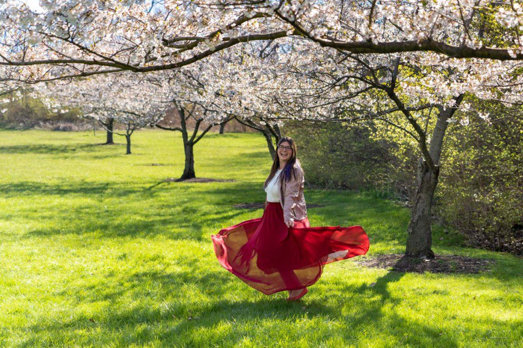 Amanda twirling under cherry trees